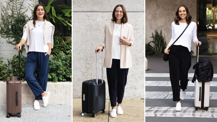 Brunette women wheeling suitcases wearing stylish, put together airport outfits.