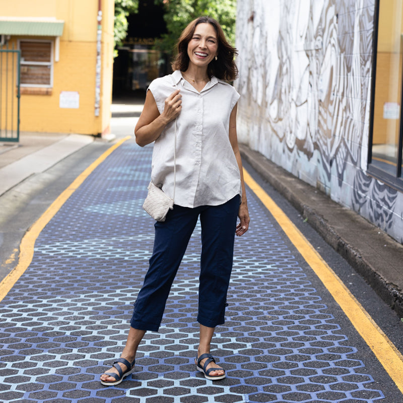 Brunette woman wearing black cargo pants and a white shirt