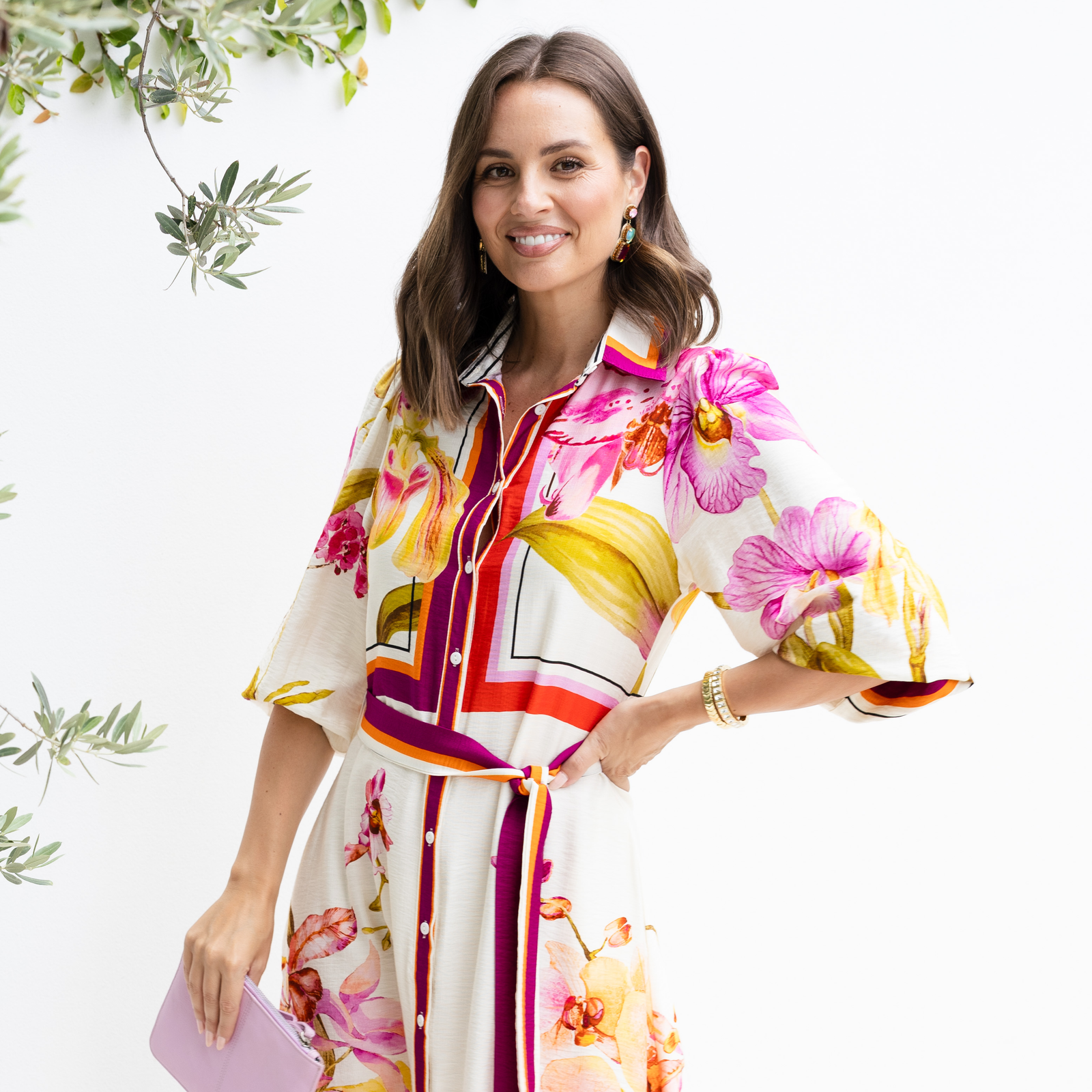 Brunette model wearing a floral event dress for a Christening. 