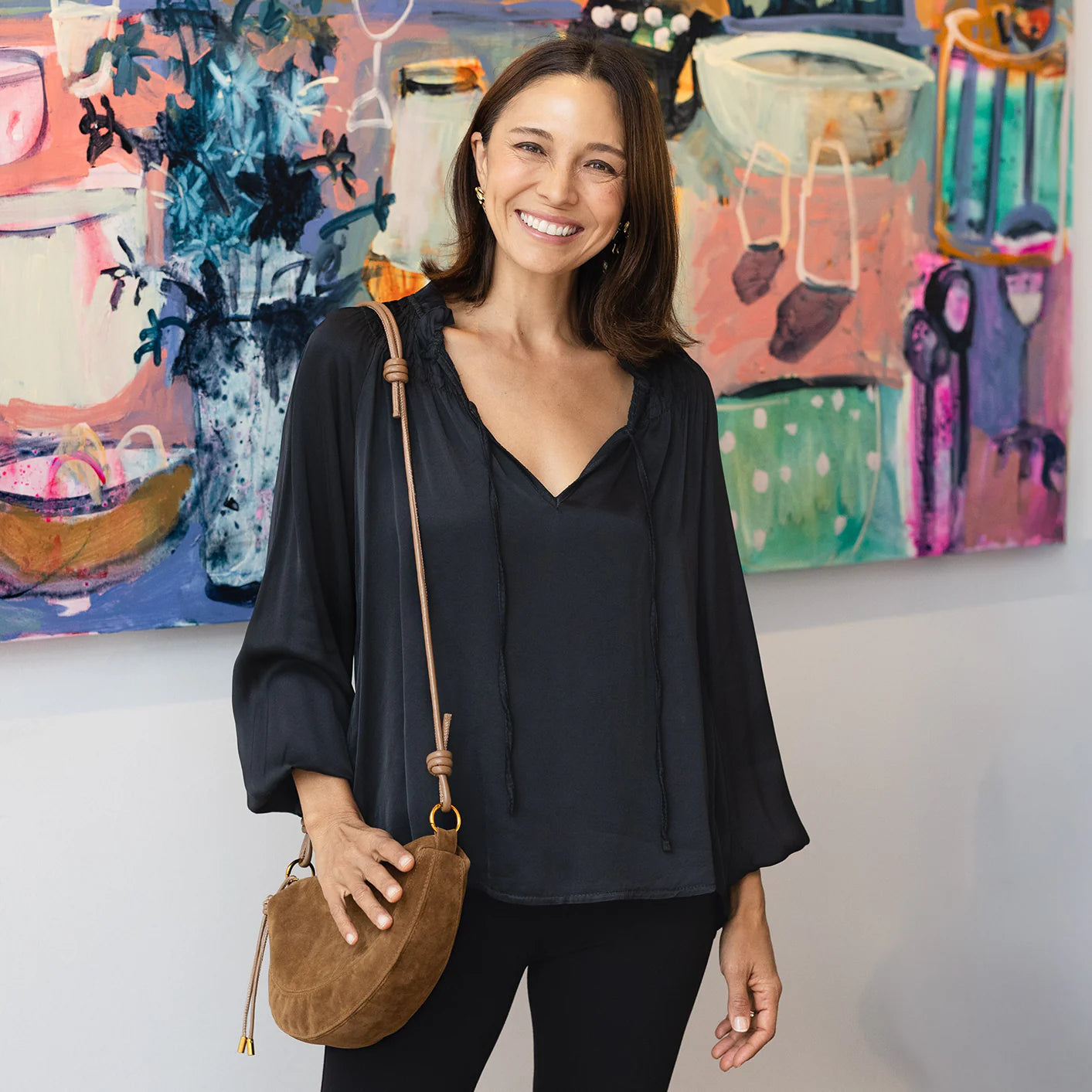 Brunette woman wearing a black blouse for a date night.