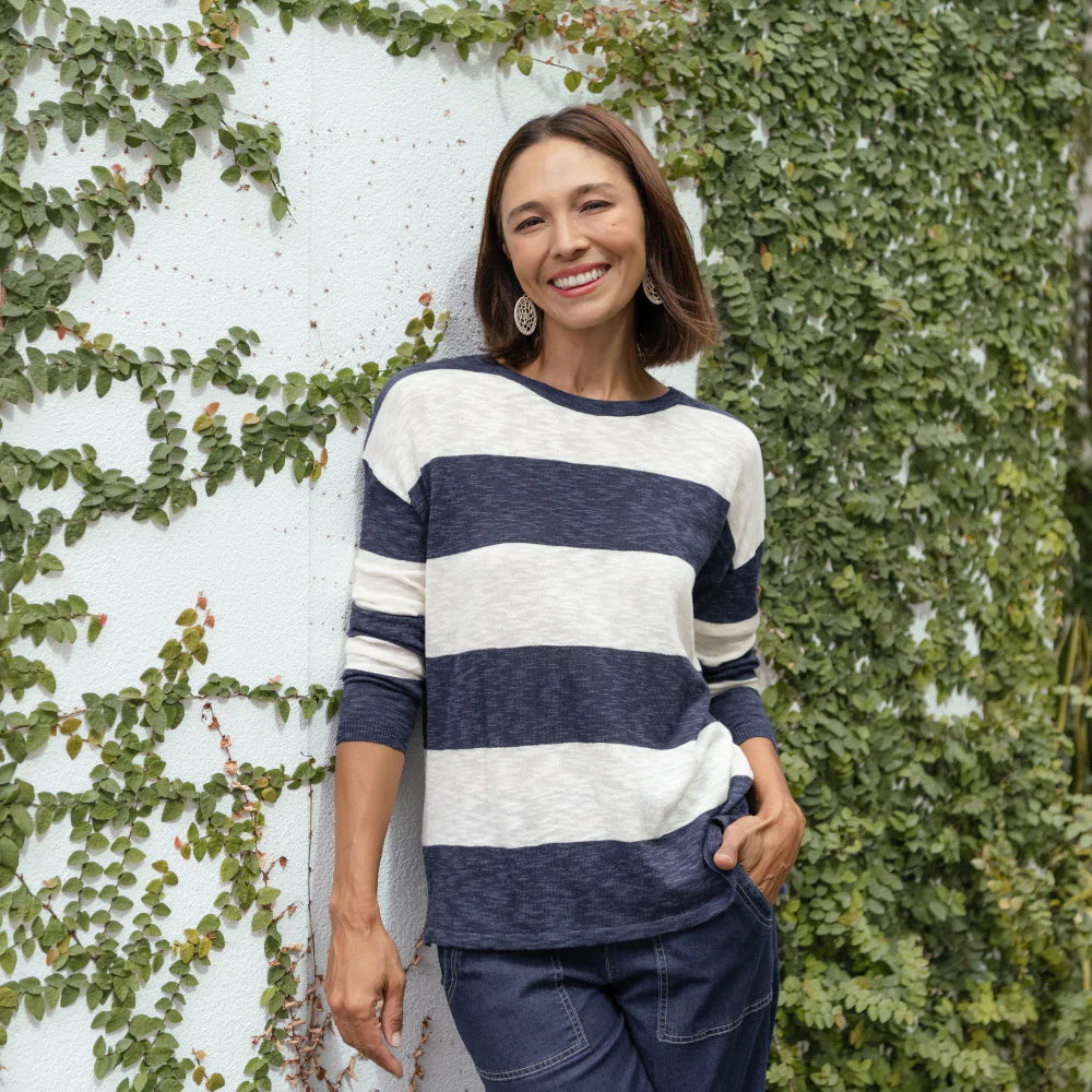 Brunette woman wearing a navy and white striped jumper for autumn style.