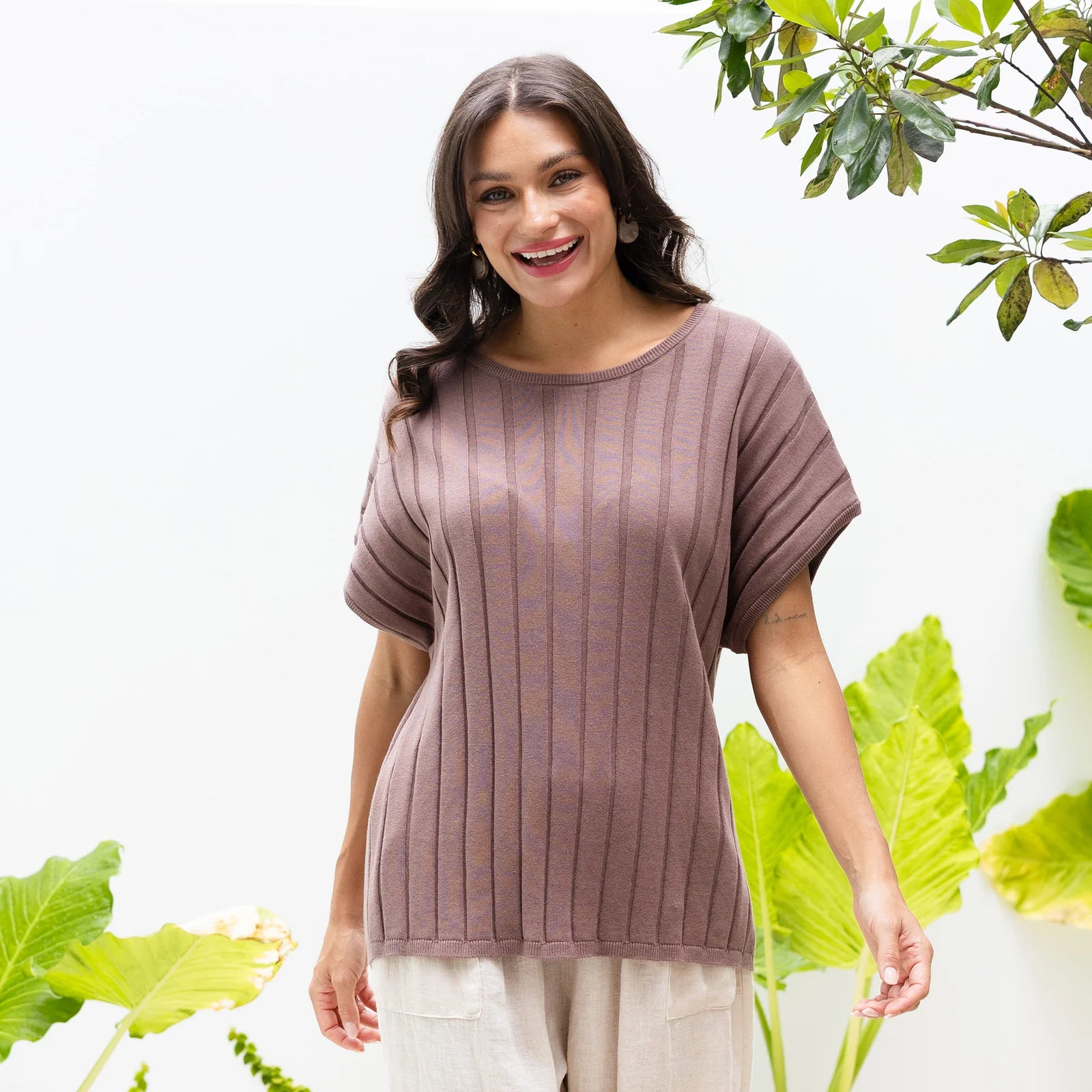 Brunette woman wearing a brown knit top for summer style.