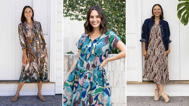 Three bruentte models in leaf-print dresses with leaves in the background 