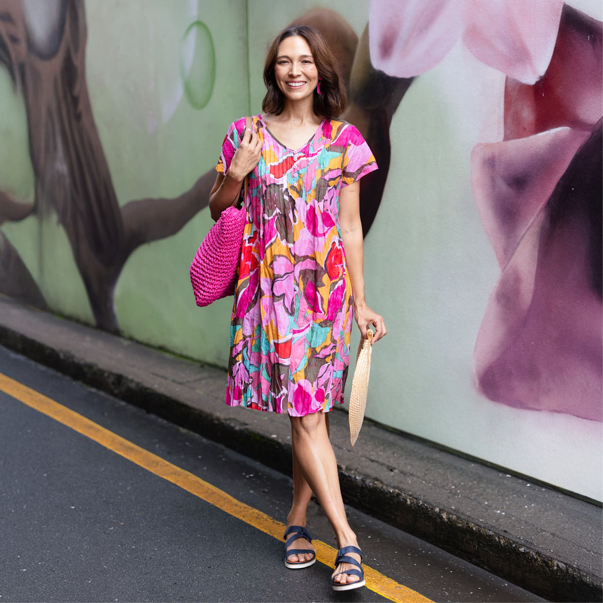 Brunette women in a bright pink printed no-iron cotton dress